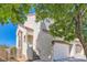 Corner view of two-story home, with desert landscaping, stucco walls, tile roof, and a two-car garage at 1672 Cloister Ave, Henderson, NV 89014