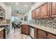 Bright kitchen featuring granite countertops, wooden cabinets and stainless steel appliances at 1672 Cloister Ave, Henderson, NV 89014