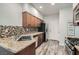 Modern kitchen with granite countertops, stainless steel appliances, and ample cabinet space for storage at 1672 Cloister Ave, Henderson, NV 89014