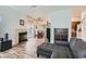 Open-concept living area with a fireplace, sliding glass doors to the patio, and wood-look flooring at 1672 Cloister Ave, Henderson, NV 89014