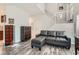 Modern living room featuring wood-look floors, a comfy couch, and stylish decor at 1672 Cloister Ave, Henderson, NV 89014