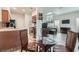 Open living space with dining, kitchen, and living room with hardwood flooring, creating a warm atmosphere at 1672 Cloister Ave, Henderson, NV 89014