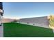 The expansive artificial lawn area is surrounded by a stone border, offering low-maintenance beauty at 168 Robledo St, Las Vegas, NV 89138