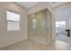 Beautiful, bright bathroom features a glass enclosed shower with marble-look tile and a window at 168 Robledo St, Las Vegas, NV 89138