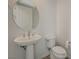 A pristine powder room includes a pedestal sink and a modern toilet at 168 Robledo St, Las Vegas, NV 89138