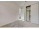 Bedroom with neutral carpet, white walls, an open closet, and open doorway at 168 Robledo St, Las Vegas, NV 89138