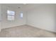 Bedroom with neutral carpet, white walls, and two windows at 168 Robledo St, Las Vegas, NV 89138
