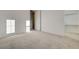 Bedroom featuring neutral carpet, white walls, an open closet, and open doorway at 168 Robledo St, Las Vegas, NV 89138