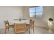 Charming dining space featuring a round marble table, stylish chairs, and ample natural light from a nearby window at 168 Robledo St, Las Vegas, NV 89138