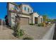 Two-story home with a two-car garage and a stone-paved driveway and walkway at 168 Robledo St, Las Vegas, NV 89138