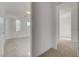 Hallway leading to a bedroom with neutral carpet and white walls at 168 Robledo St, Las Vegas, NV 89138