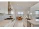 Well-lit kitchen with a gas range, stainless steel hood, and a dining area, perfect for modern living at 168 Robledo St, Las Vegas, NV 89138