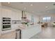 Modern kitchen featuring white cabinets, stainless steel appliances, and a spacious center island with marble countertop at 168 Robledo St, Las Vegas, NV 89138