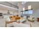 Bright living room showcases soaring ceilings and expansive windows with an adjacent kitchen and dining area at 168 Robledo St, Las Vegas, NV 89138