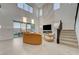 Bright living area with large windows, a modern fireplace, and staircase leading to upper level at 168 Robledo St, Las Vegas, NV 89138