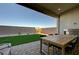 Covered patio boasts a brick floor, built in fireplace, and an outdoor dining area at 168 Robledo St, Las Vegas, NV 89138