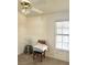 Simple bedroom with a window, neutral walls, and a ceiling fan for comfort at 1812 Jack Rabbit Way, Las Vegas, NV 89128