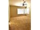 Large bedroom with two windows, neutral carpet, and a ceiling fan at 1812 Jack Rabbit Way, Las Vegas, NV 89128