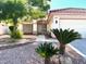 Charming single-story home features a well-manicured front yard, two palm trees and a two-car garage at 1812 Jack Rabbit Way, Las Vegas, NV 89128