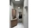 Hallway with storage cabinets and natural light from skylight above doorway at 1812 Jack Rabbit Way, Las Vegas, NV 89128