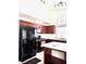 Well-lit kitchen with dark wood cabinets, island, and modern appliances at 1812 Jack Rabbit Way, Las Vegas, NV 89128