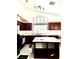 Well-lit kitchen with dark wood cabinets, island, and modern appliances at 1812 Jack Rabbit Way, Las Vegas, NV 89128