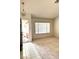 Bright living room with neutral carpet, large window, and a welcoming entrance at 1812 Jack Rabbit Way, Las Vegas, NV 89128
