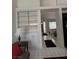 Bright living area with built-in shelving, white cabinets, and a view of the entry door at 1812 Jack Rabbit Way, Las Vegas, NV 89128