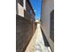 Narrow side yard with gravel landscaping and a concrete walkway, enhancing the property's exterior at 1812 Jack Rabbit Way, Las Vegas, NV 89128