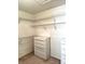 Walk-in closet featuring wire shelving and a chest of drawers on carpet at 1812 Jack Rabbit Way, Las Vegas, NV 89128