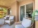 Charming balcony with rocking chairs and a glimpse into the stylish home interior at 20 Via Mantova # 208, Henderson, NV 89011