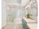 Luxurious bathroom featuring double sinks, soaking tub, and glass enclosed shower at 20 Via Mantova # 208, Henderson, NV 89011
