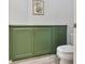 Bathroom featuring green cabinets, decorative wall art, and light wood-look flooring at 20 Via Mantova # 208, Henderson, NV 89011