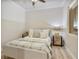 Cozy bedroom featuring neutral tones, laminate flooring, and a stylish lamp at 20 Via Mantova # 208, Henderson, NV 89011