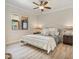 Inviting bedroom featuring a ceiling fan, laminate flooring, and lots of natural light at 20 Via Mantova # 208, Henderson, NV 89011