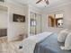 Bright bedroom features a ceiling fan, TV, sliding closet doors, and laminate flooring at 20 Via Mantova # 208, Henderson, NV 89011