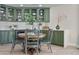 Light-filled dining area boasts sage green cabinets and ample storage at 20 Via Mantova # 208, Henderson, NV 89011
