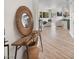 Open concept foyer leads to the living room with a decorative mirror and stylish table at 20 Via Mantova # 208, Henderson, NV 89011