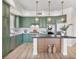 Stylish kitchen features sage green cabinets, stainless appliances, and modern pendant lighting at 20 Via Mantova # 208, Henderson, NV 89011
