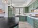 Elegant kitchen boasts sage green cabinetry, stainless steel appliances, and sleek countertops at 20 Via Mantova # 208, Henderson, NV 89011