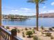 Picturesque lake view with lush landscaping, swaying palms, and tranquil waters at 20 Via Mantova # 208, Henderson, NV 89011