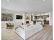 Bright living room with fireplace open to the kitchen, and hardwood floors throughout at 20 Via Mantova # 208, Henderson, NV 89011