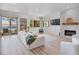 Bright, spacious living room with fireplace, neutral decor, and access to an outdoor balcony at 20 Via Mantova # 208, Henderson, NV 89011
