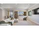 Bright living room features a water view, cozy seating, and built in shelving at 20 Via Mantova # 208, Henderson, NV 89011