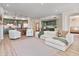 Open-concept living room seamlessly connects to the kitchen with modern appliances at 20 Via Mantova # 208, Henderson, NV 89011