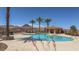 Gorgeous pool area with clear blue water, palm trees, and a cabana for relaxing at 20 Via Mantova # 208, Henderson, NV 89011