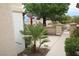 Well-maintained front yard with palm trees and a paved walkway, leading to a gated entrance at 2013 Capestone St, Las Vegas, NV 89134