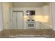 Clean kitchen with white cabinetry, modern appliances, and a pass-through breakfast bar at 2013 Capestone St, Las Vegas, NV 89134