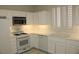 Bright kitchen featuring white appliances, countertops, and cabinetry with plenty of natural light at 2013 Capestone St, Las Vegas, NV 89134