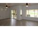 Spacious living room with tile floors, ceiling fans, and sliding door access to the patio at 2013 Capestone St, Las Vegas, NV 89134
